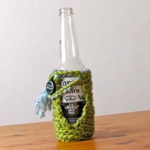 green_hand_crocheted_beer_cozy_with_light_blue_scarf_f4e26229