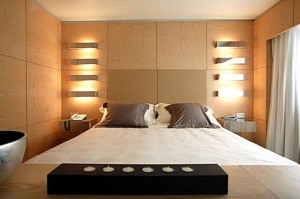 dark-sconces-and-metal-sconces-besides-bed-915x610