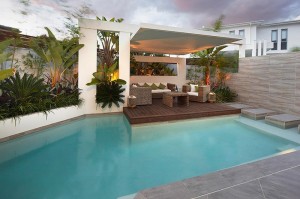 Custom-Pool-Area-undercover-patio-lounge-with-garden-beds-and-palms