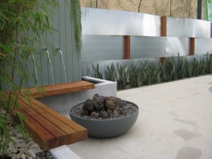 Faux-fire-bowl-green-form-woven-steel-wall-and-water-feature-falling