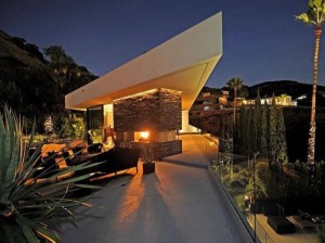 futuristic-duke-residence-with-fireplace-design-outdoor-chair-and-modern-lighting-630x472