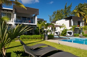 Exterior-modern-design-apartment-resort-Mauritius-blue-water-swimming-pool-trees-palm-tile-floor-window-black-embroidered-seats-umbrella-stairs-ornamental-green-grasses-natural-stone-wall-relax