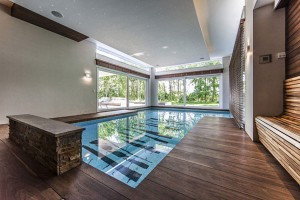 Luxurious-indoor-pool-Stone-bench-Wooden-deck-Glass-bay-window