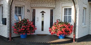 White-Front-Door-Design-with-Two-Flower-Pots-600x300