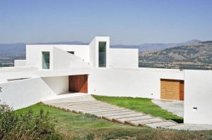 outdoor-stairs-and-small-garden-modern-house-design-in-the-hills-with-white-exterior-color-and-wooden-door