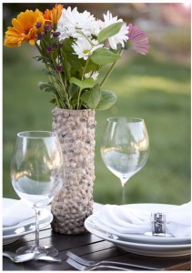 fresh-outdoor-table-decoration-with-rock-covered-vase-made-from-pringles-can-on-the-darkwood-table-with-glass-and-plate