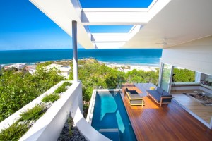 outdoor-pool-contemporary-beach-house-design-with-glass-railings-and-deck-with-wooden-floor-tiles-plus-black-sofa-ideas