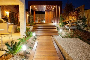 wooden-deck-walkway-with-stones-and-lighting